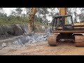 330 caterpillar excavator with hydraulic jackhammer breaking rocks