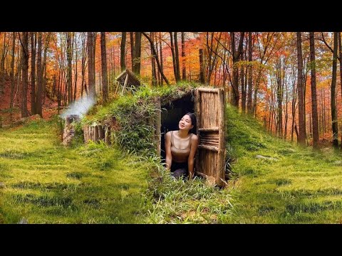 The beautiful girl builds a warm shelter for survival outdoors in the ...