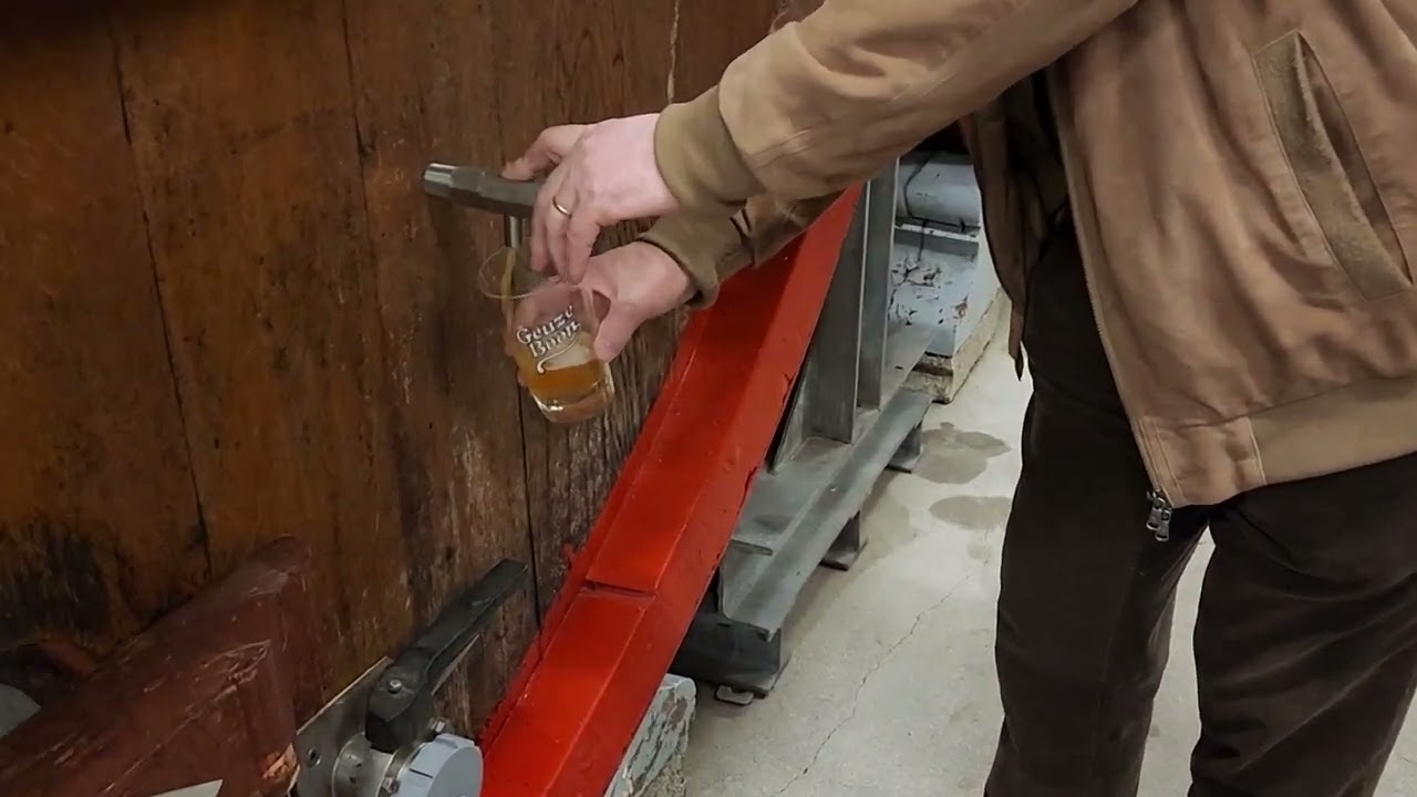 Frank Boon pours another glass of three year old lambic from Foeder 61 at Brouwerij Boon (close up.)
