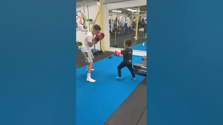 Henry shepherd (age 6 ) on the pads with coach Sonny