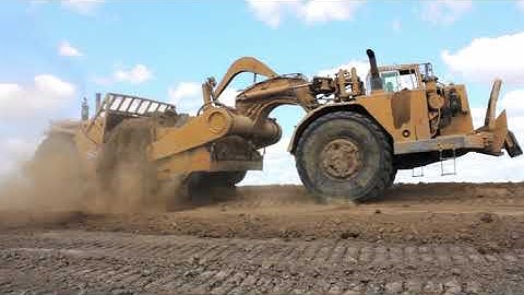 Cat 637 Twin Engine Scrapers Loading in the Cut Doing Land Balancing- Heavy Equipment Land Balancing