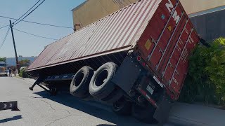 Container comes close to tipping over  lands on building