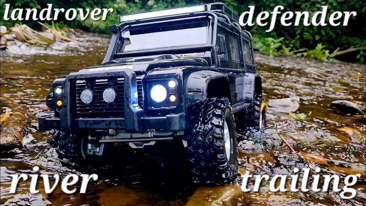 landrover defender trailing down the river