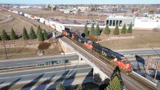 Awesome Aerial 4K View! Very Long Stack Train CN 120 w/ex BN EMD Geep & DPU passing thru Moncton, NB