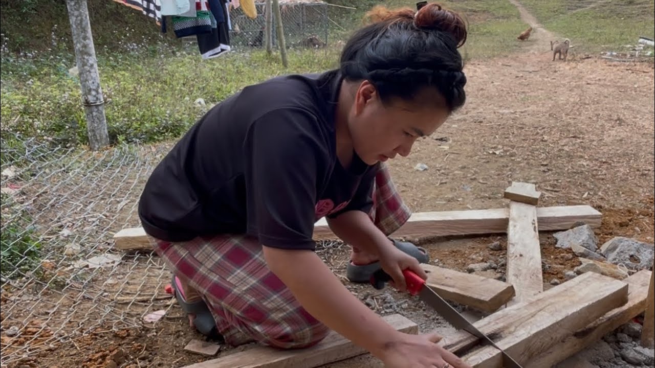 The woman raising two young children made a wooden gate to welcome lunar New Year.