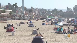 Tourists And Growing Homeless Encampment Share Santa Cruz Sands