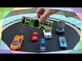 12 toy cars dancing on a trampoline.