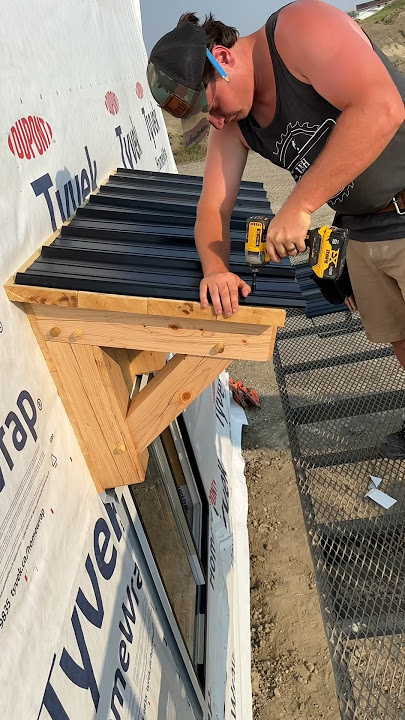More roofing tin going on more door and window awnings #construction #workshop #tools