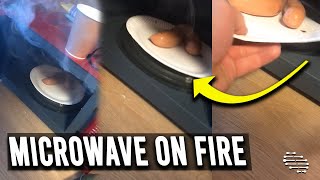 Microwave Started Burning as Guy Looks Inside to Understand Why Is It on Fire