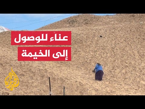 معاناة مُسنة في صعود تل للوصول لخيمتها برفح في قطاع غزة