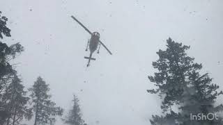 Flying a helicopter in a blizzard | landing on a mountain side in near whiteout conditions