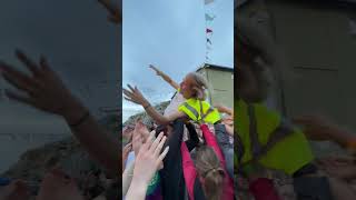 Guy Falls to the Ground Amidst the Crowd Surfing Excitement at a Concert