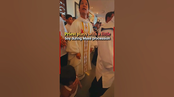 Joyful moment as a priest warmly interacts with a little boy during Mass procession #mass #priest
