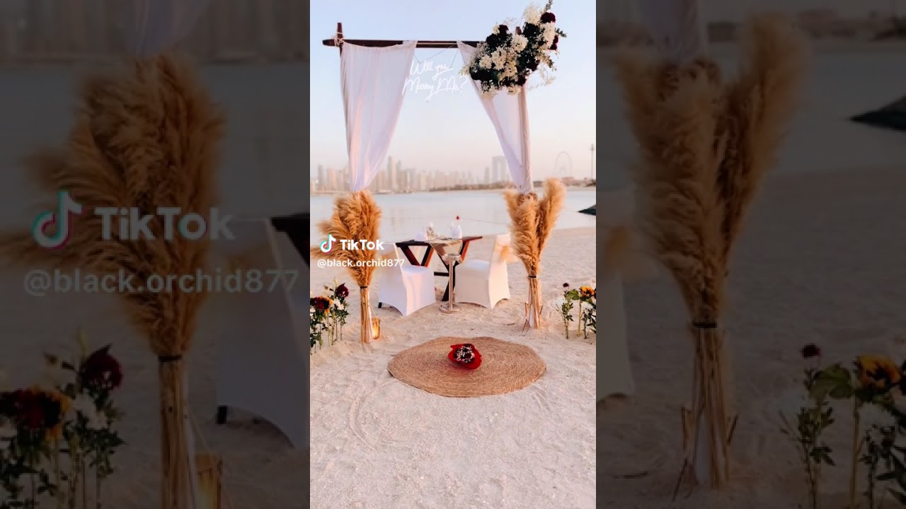 Beach proposal with arch and fresh flowers😍