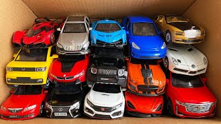 Box full of model Cars, Tesla, Lamborghini, SLR, Rolls Royce, Maybach, BMW, Mini EV.