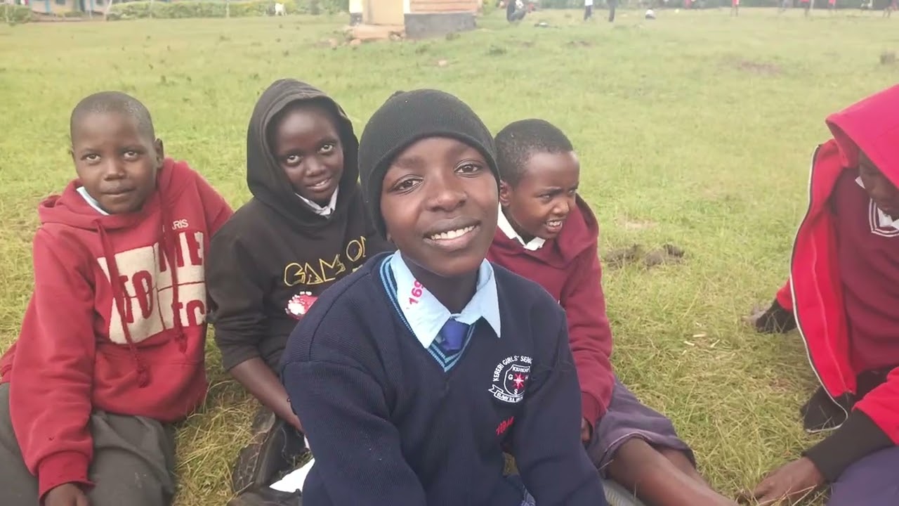 Girl guide speaking to her former schoolmates as they visited them for a charity donation.