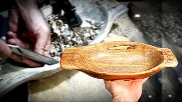 Woodcarving rustic a bowl with handcrafted tools