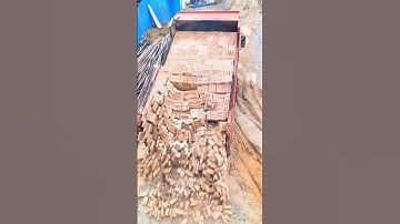 The process of unloading bricks from a dump truck