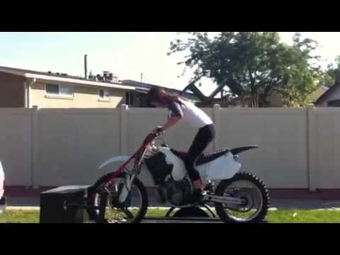 Cute excited girl starts dirtbike