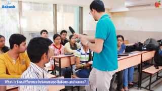 What is the difference between oscillations and waves