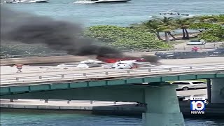 Small plane on fire over bridge in Miami