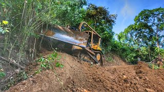 Good job, very powerful D6R XL bulldozer operator cutting cliffs to widen mountain roads