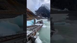 Abandoned temporary construction bridge destroyed by glacial lake outburst flood, ice chunks and ste