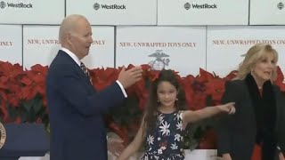 Little girl leads Joe Biden off stage at an event