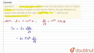 A parallel plate capacitor has circular plates, each of radius 5.0 cm. It is being charged so th...