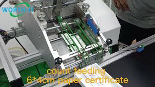 Counting feeding inserts small paper certificate onto running transport belts