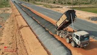 Wonderful Construction Dump Truck Spreading Gravel With Motor Grader Plowing On The New Road