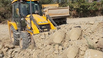 JCB Backhoe-Hastily Loading Gravel in a Dump Truck