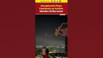 Thumbnail of Iran-Israel War Visuals: Saxophonist Plays On as Iranian Missiles Light Up Sky