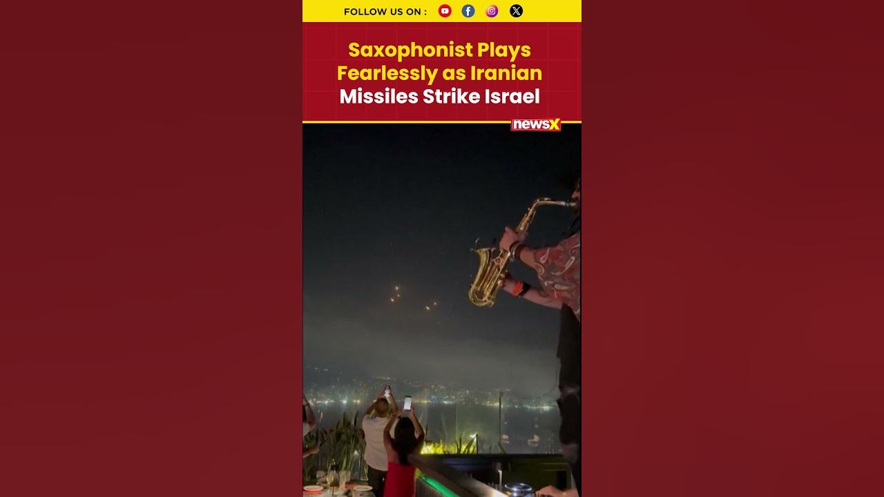 Iran-Israel War Visuals: Saxophonist Plays On as Iranian Missiles Light Up Sky