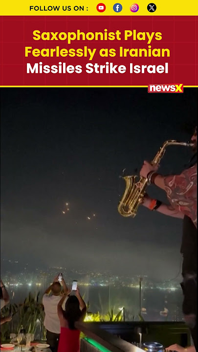 Iran-Israel War Visuals: Saxophonist Plays On as Iranian Missiles Light Up Sky