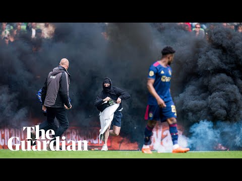 Ajax game suspended as Groningen fans invade pitch to protest relegation