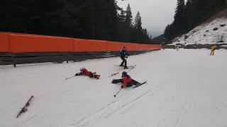 Skier rides downhill at full speed then crashes into little boy on skis