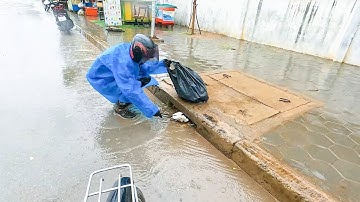 Clogged Culvert Drain Removing And Picking Up Trash On Street Drain Unclogging