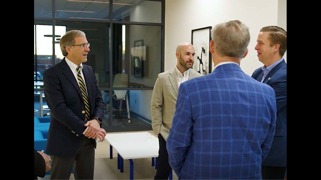 Image of men talking in a circle