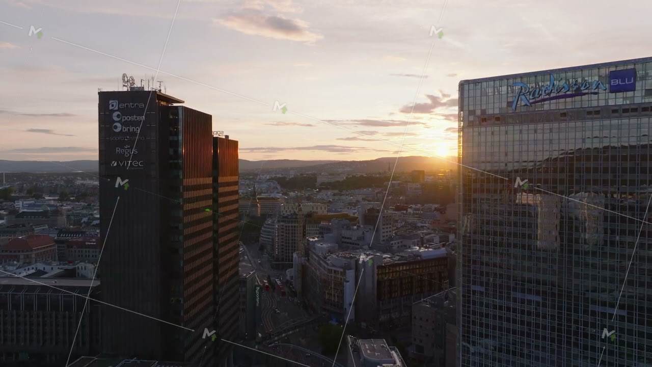 Forwards fly between modern high rise buildings in large city. Romantic sunset sky in background
