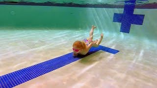 Elizabeth Swims across the bottom of the pool. She tries to swim the length of the pool underwater