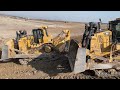 Caterpillar d8r and caterpillar d9t bulldozers working on huge mining area  mega machines movie