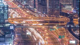 Night traffic on a busy intersection on Sheikh Zayed road highway aerial timelapse.