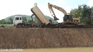 Excavator CAT 320C Digging Dirt And Dump Truck Working Restoration Canals