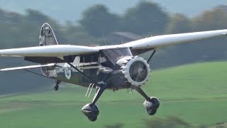 Vintage private collector planes landing on grass