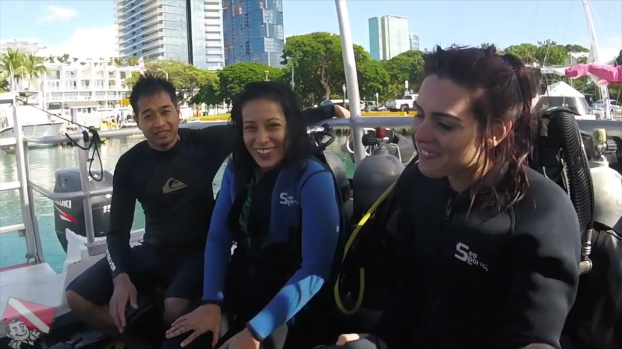 A happy first-time diver smiles after an incredible scuba tour in Honolulu.