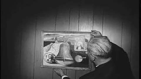 Paul Cooley and unidentified man hanging artwork, ...