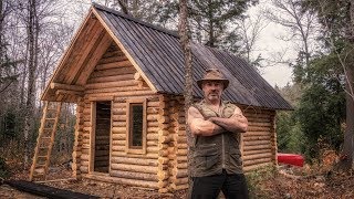 One man builds a cheap, rustic log cabin in the Canadian wilderness alone and without power tools over several months in 2017.