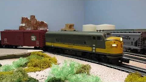 Atlas O scale Grand Trunk Western F3 diesel pulling a short freight train with a GTW wood caboose