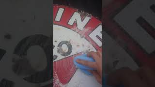 cleaning up a porcelain sign